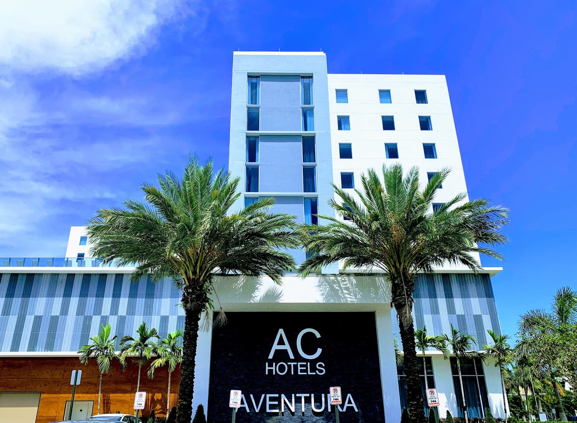 AC Hotel Miami Aventura exterior view with palm trees