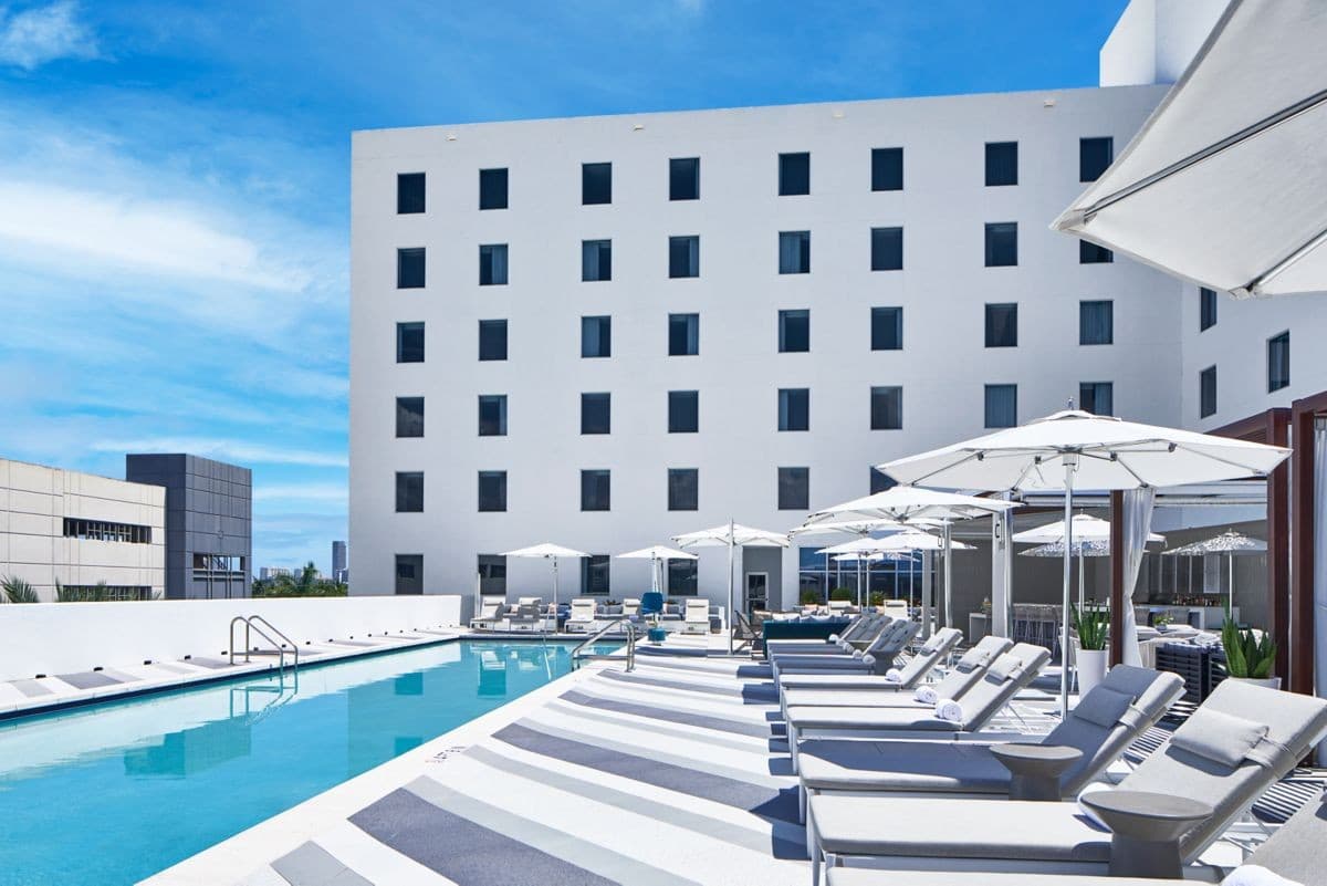 AC Hotel Miami Aventura pool area with lounge chairs