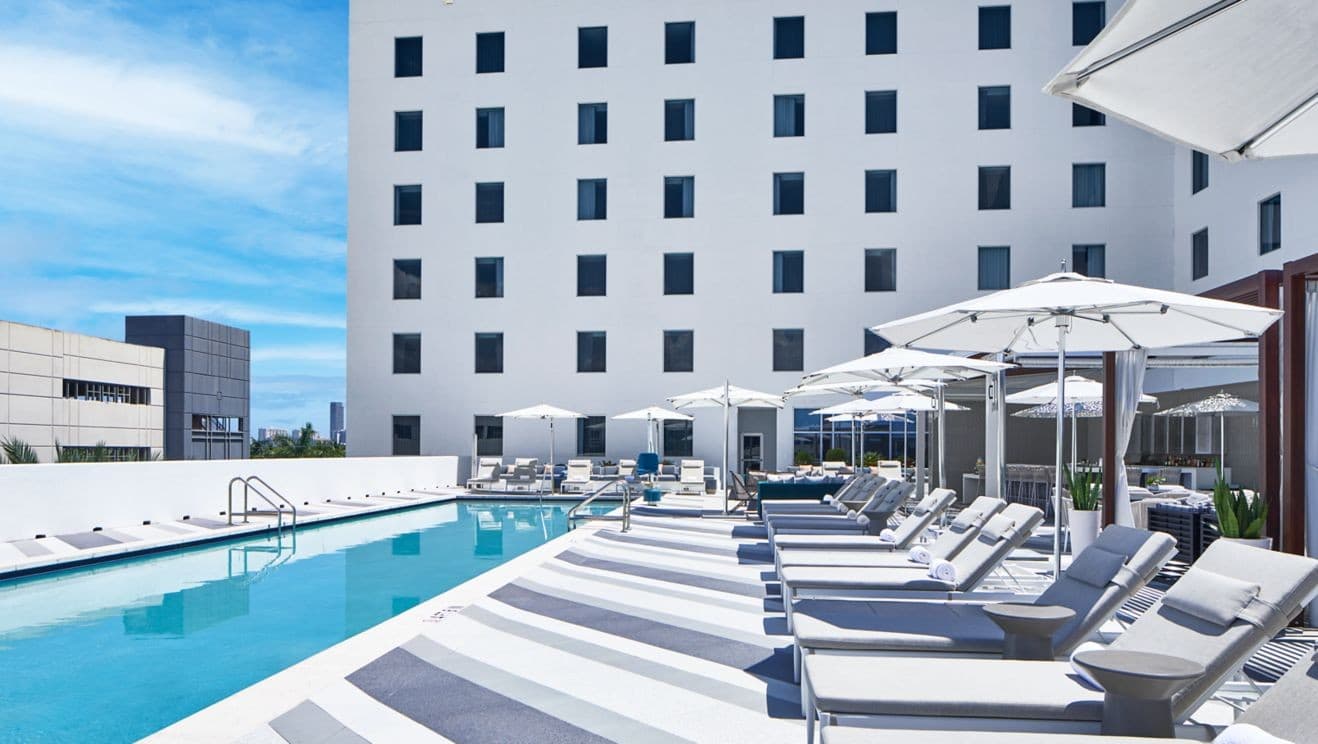 AC Hotel Miami Aventura pool area with lounge chairs