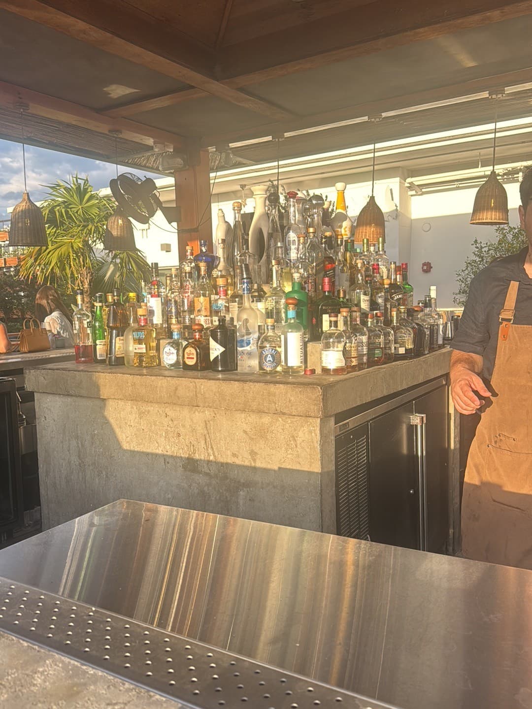 Bar at Astra Miami Rooftop showcasing variety of spirits