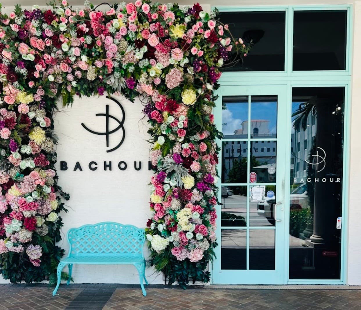 Bachour restaurant entrance in Coral Gables with floral decor