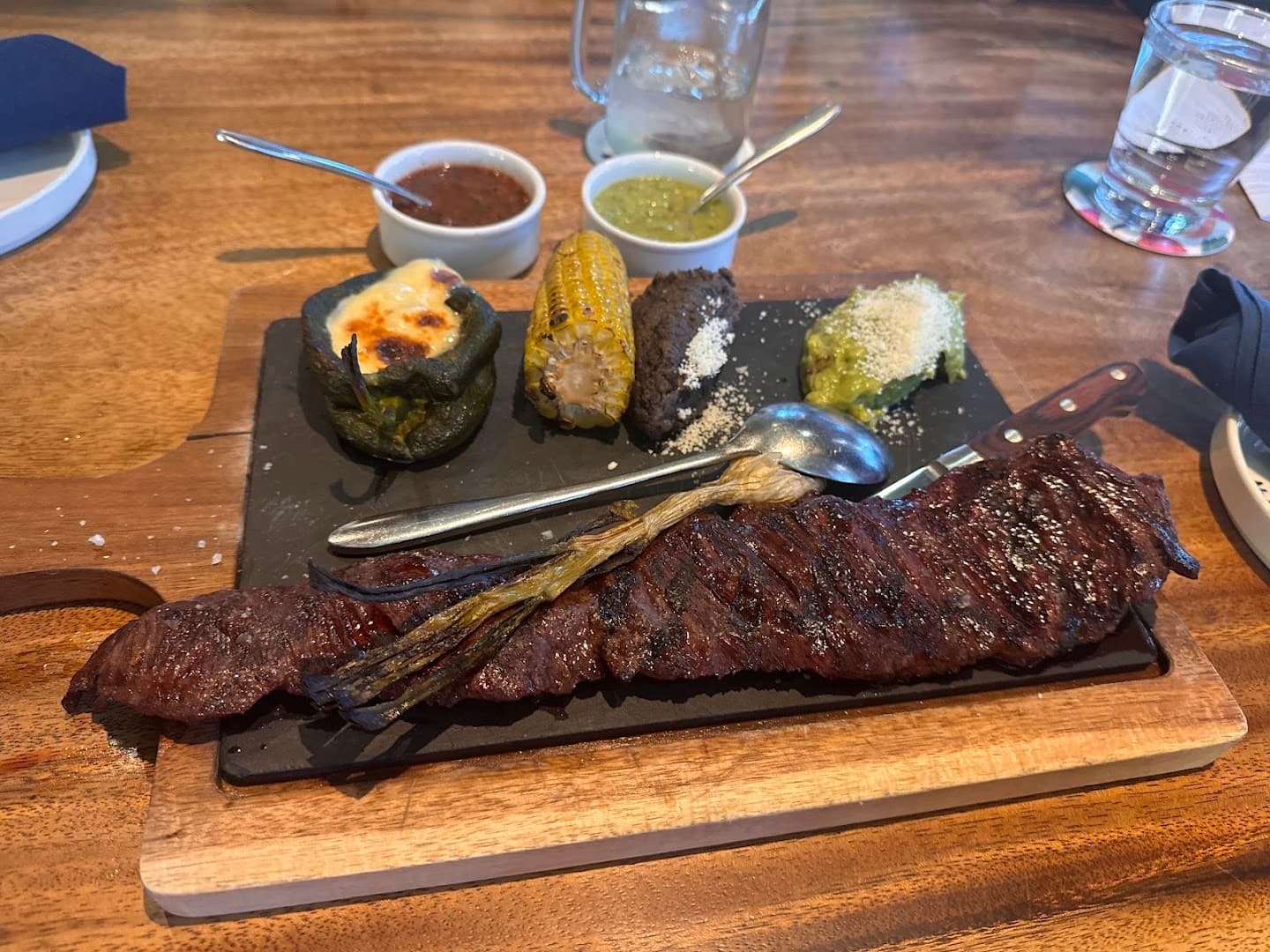 Grilled steak and sides at BAKAN Miami