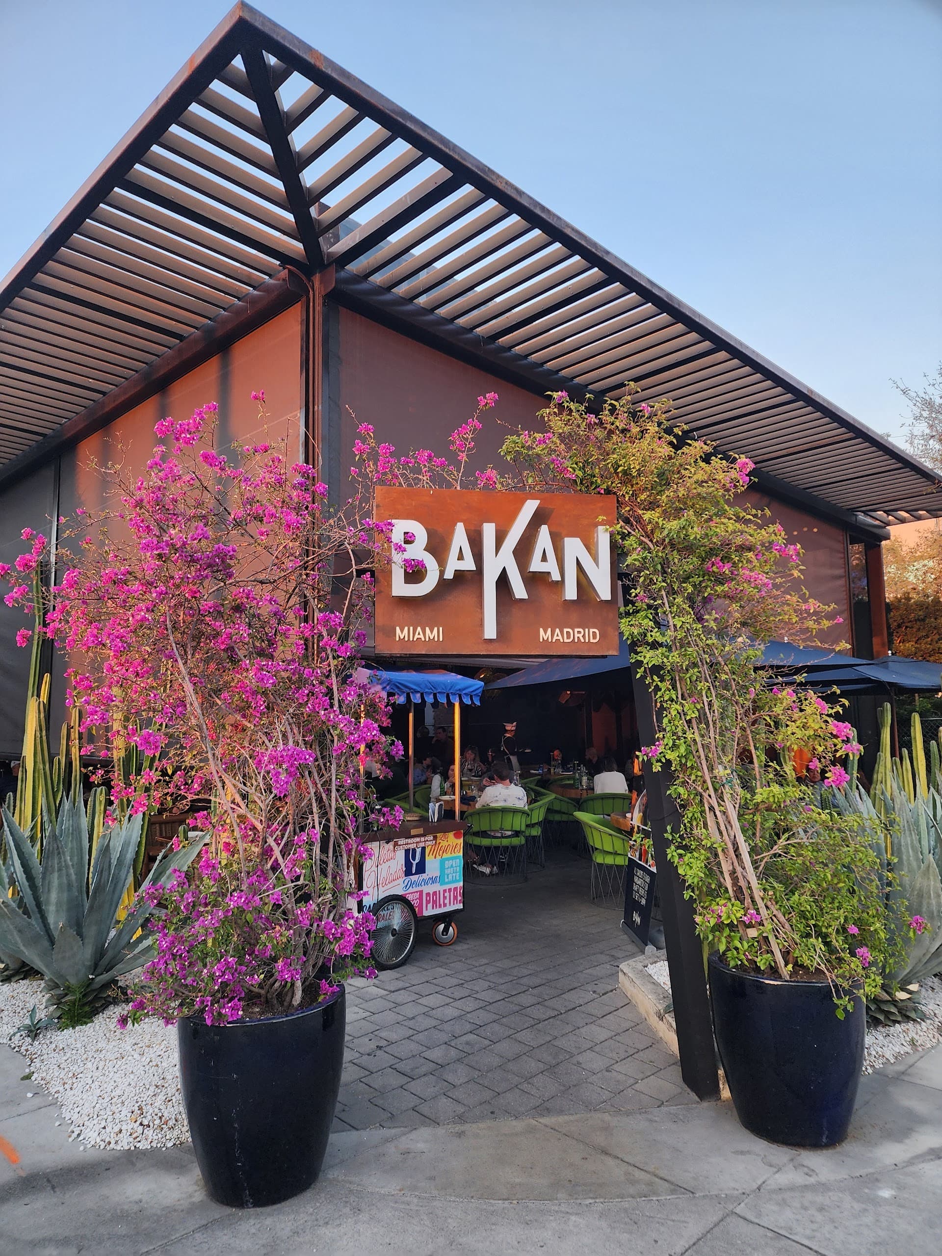 BAKAN restaurant entrance with vibrant flowers in Miami