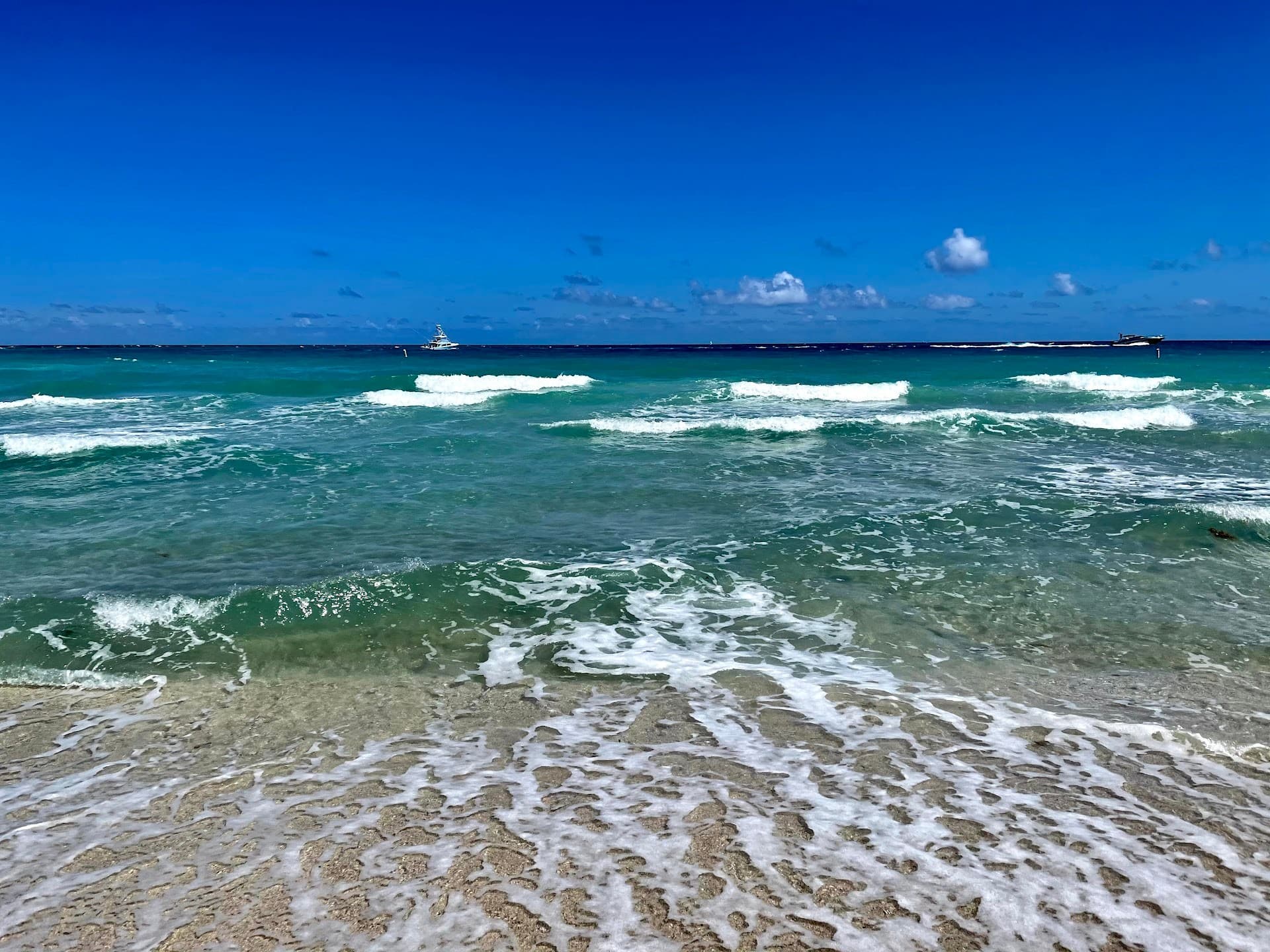 Bal Harbour Beach view with waves and blue sky Miami