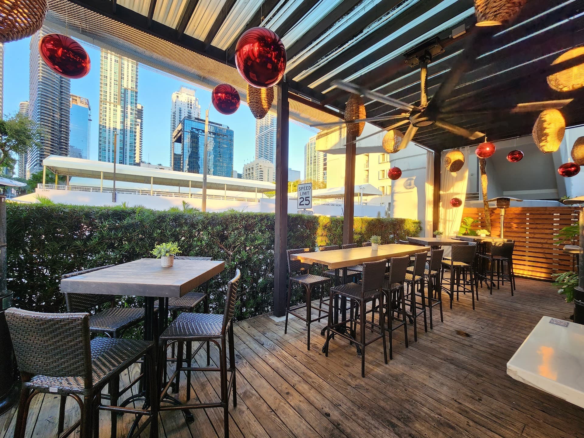Outdoor patio at Barsecco in Miami with urban backdrop