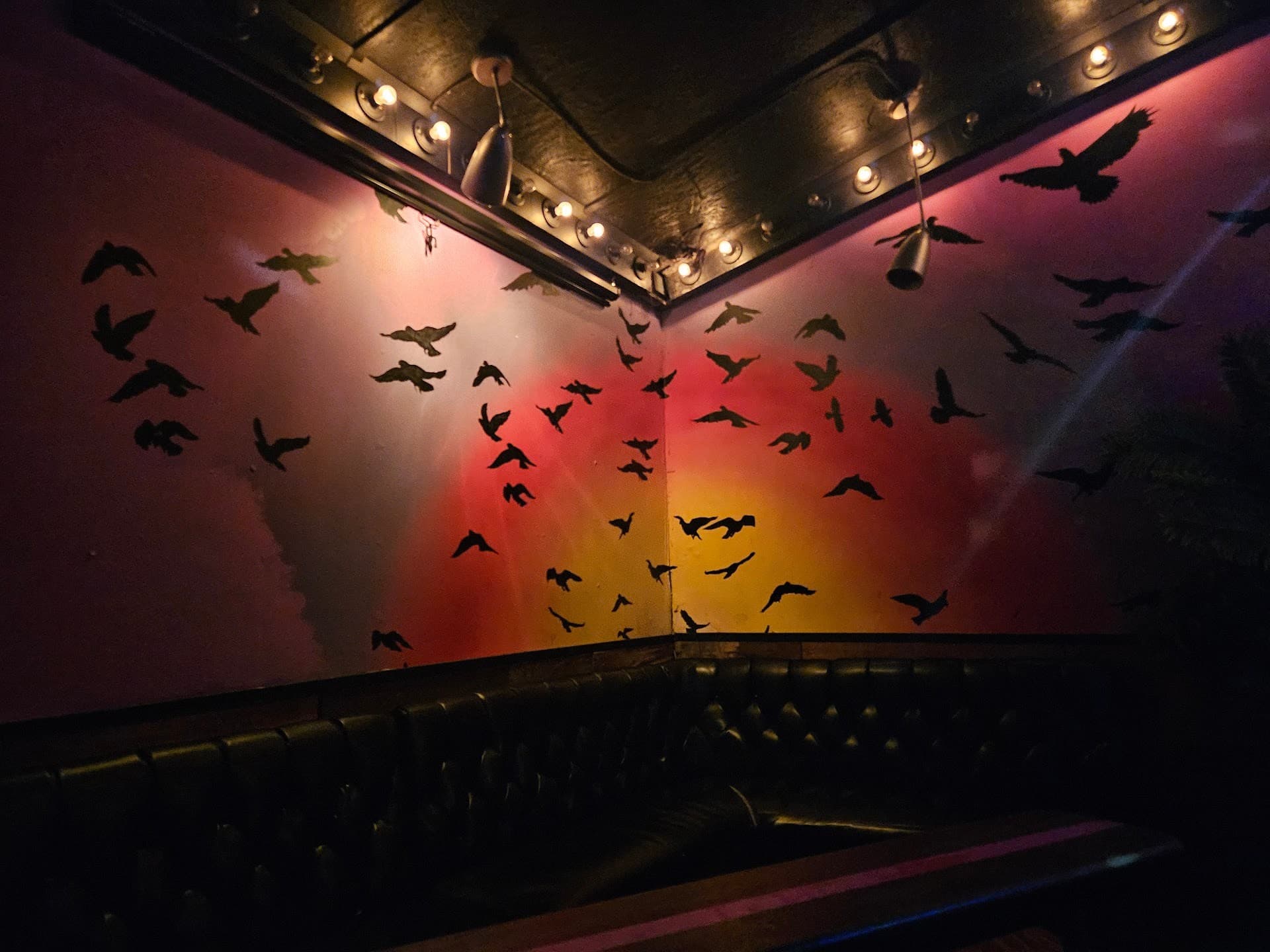 Interior view of Blackbird Ordinary in Miami with bird mural