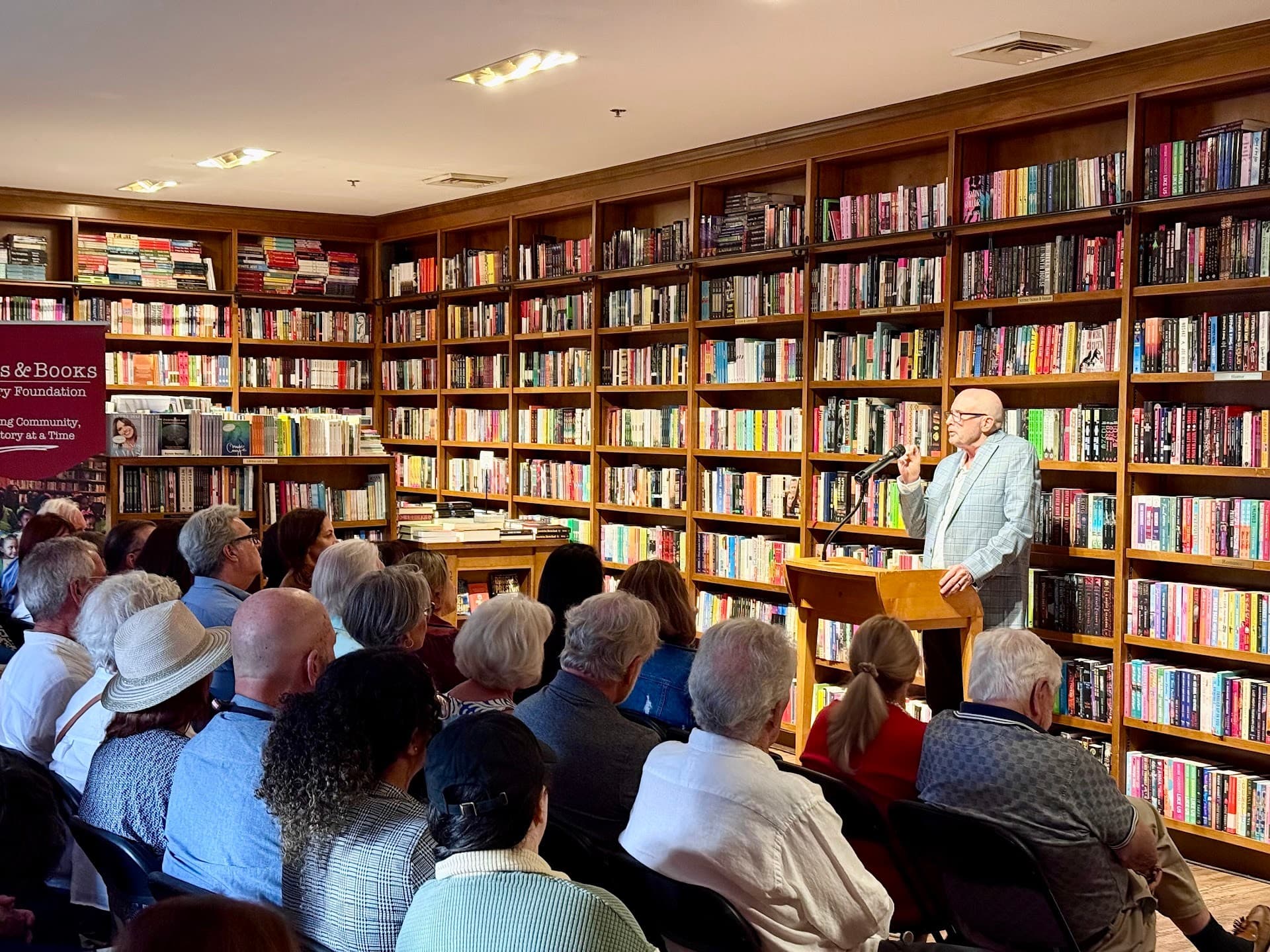 Books & Books interior with a speaker in Coral Gables