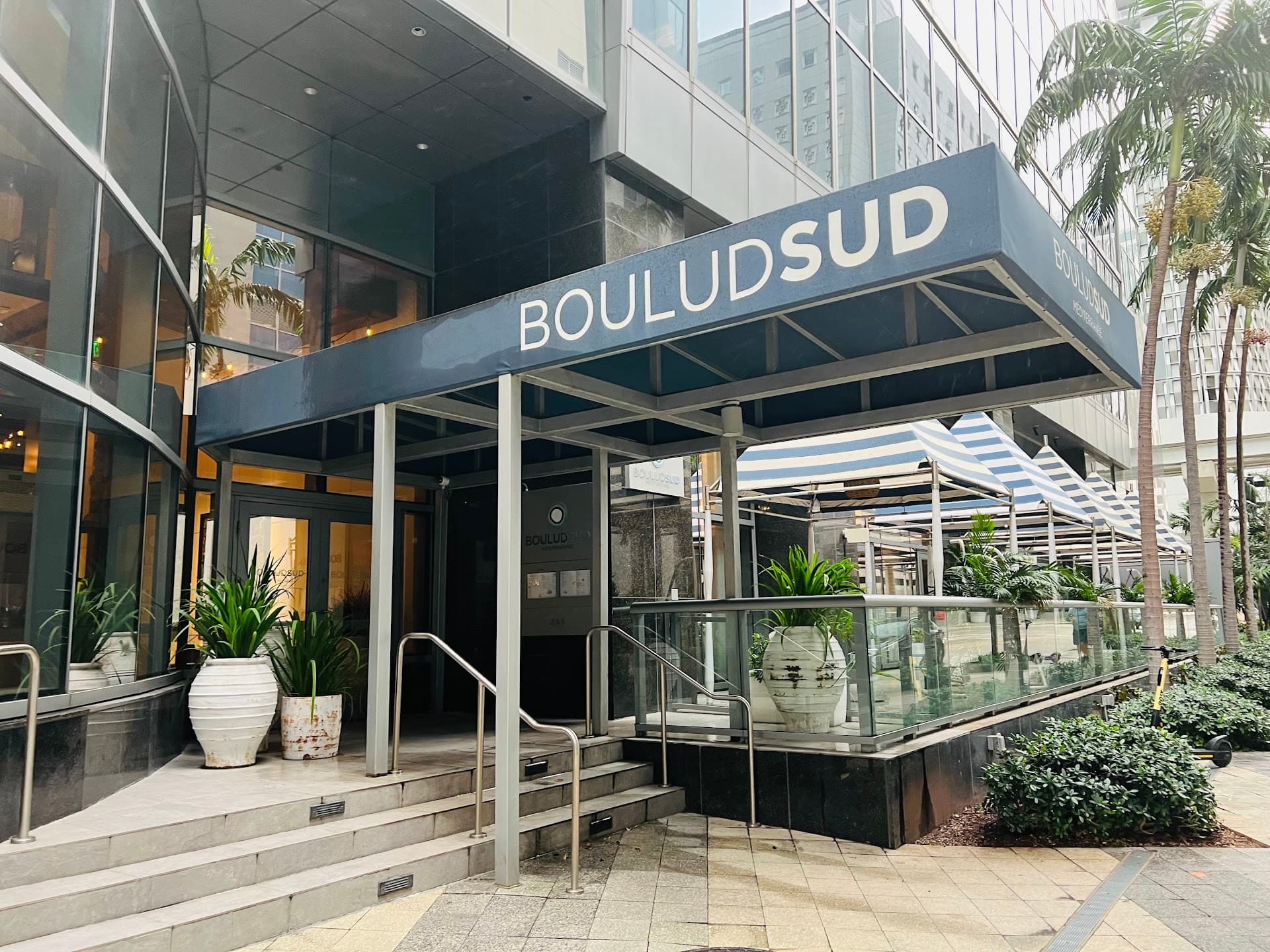 Boulud Sud Miami entrance sign and patio area