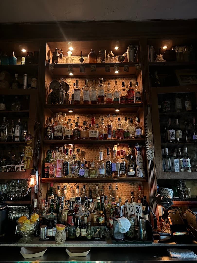 Broken Shaker bar shelf with various spirits in Miami Beach