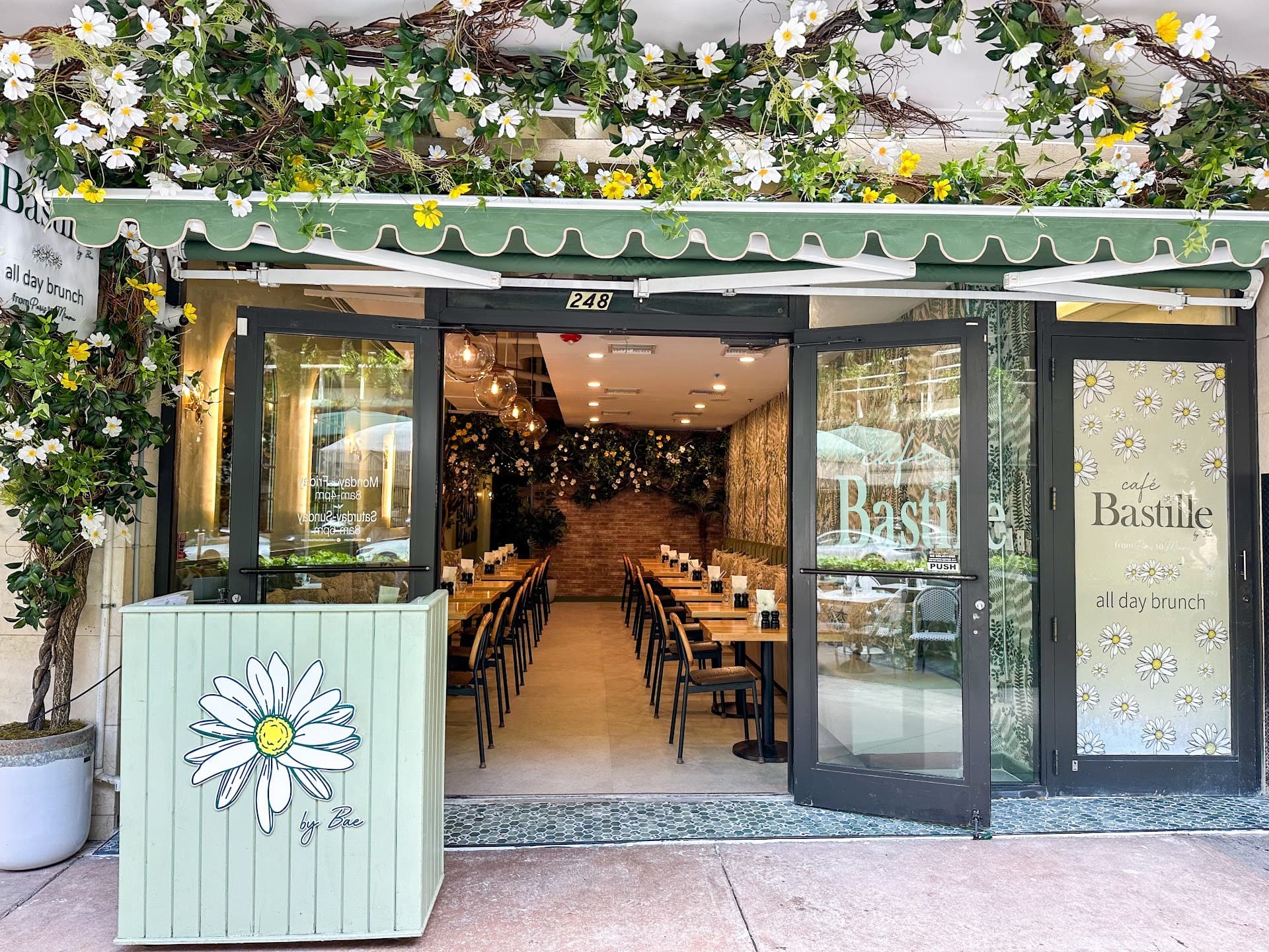 Café Bastille Downtown Miami exterior with floral decor
