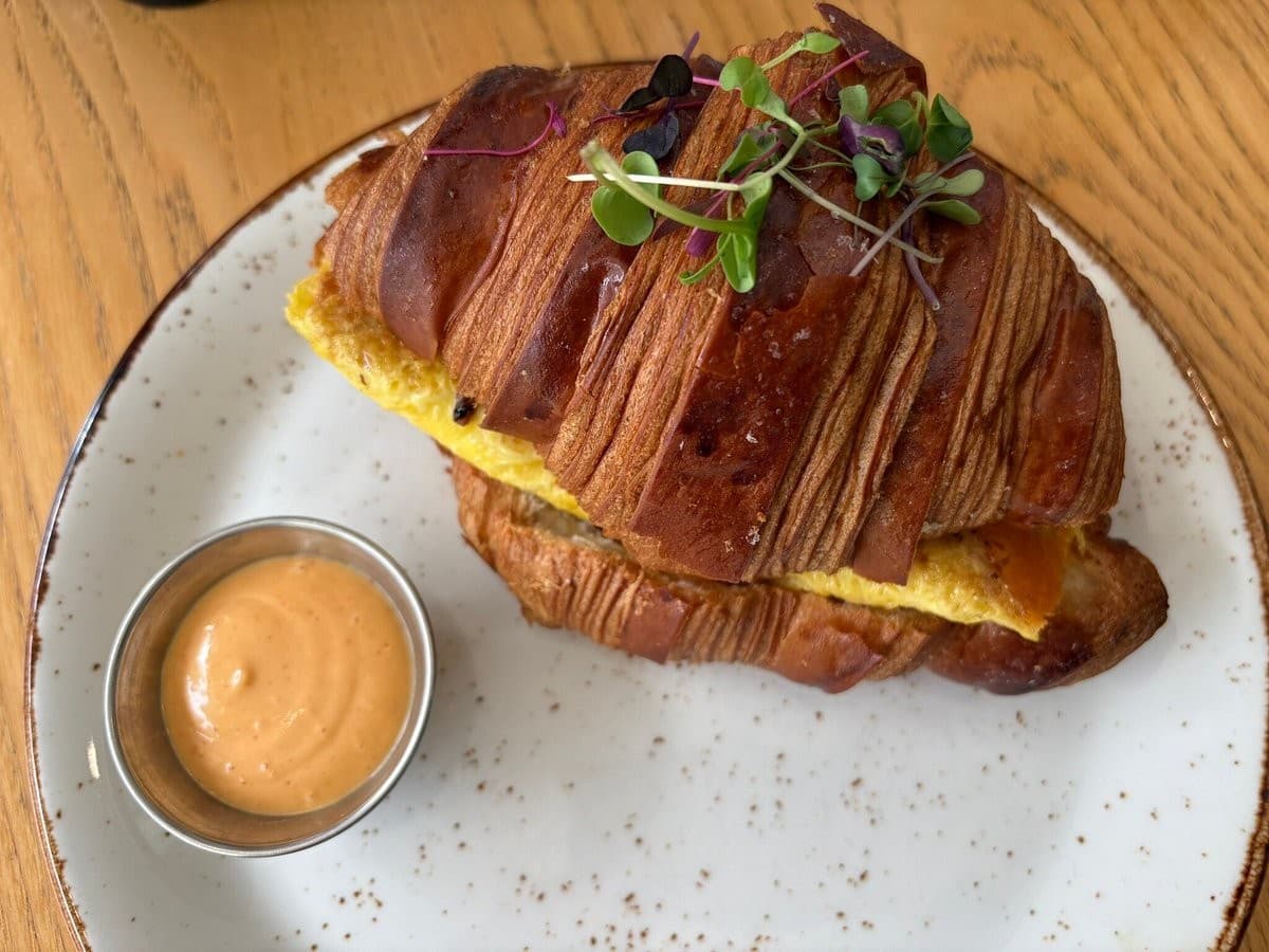 Croissant sandwich with sauce at Café Bastille Miami Beach