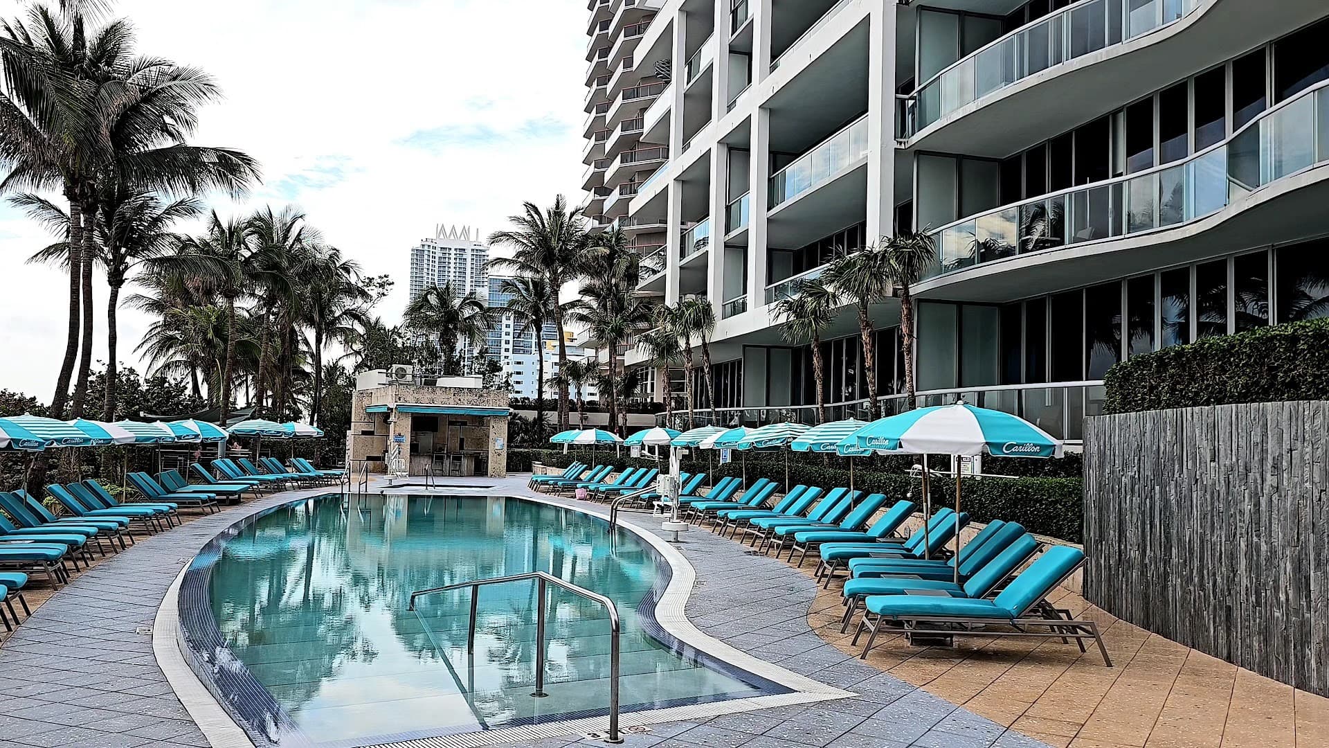 Carillon Miami Wellness Resort pool area with lounge chairs