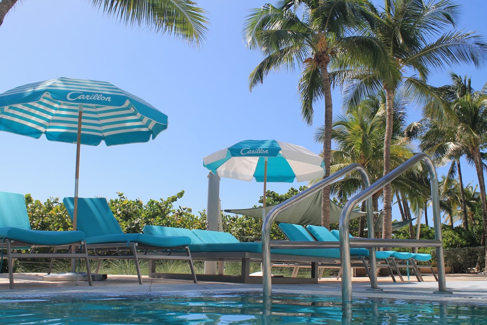Carillon Miami Wellness Resort pool area with umbrellas