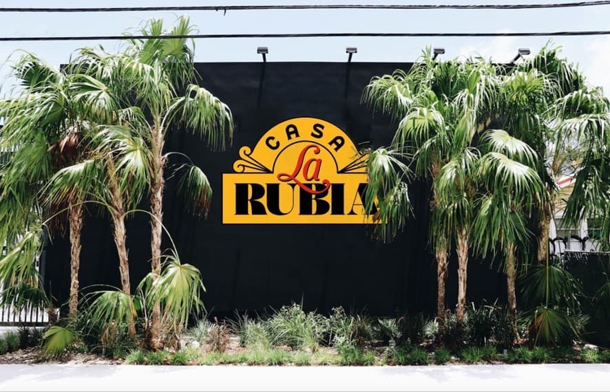 Casa La Rubia sign in Miami with palm trees