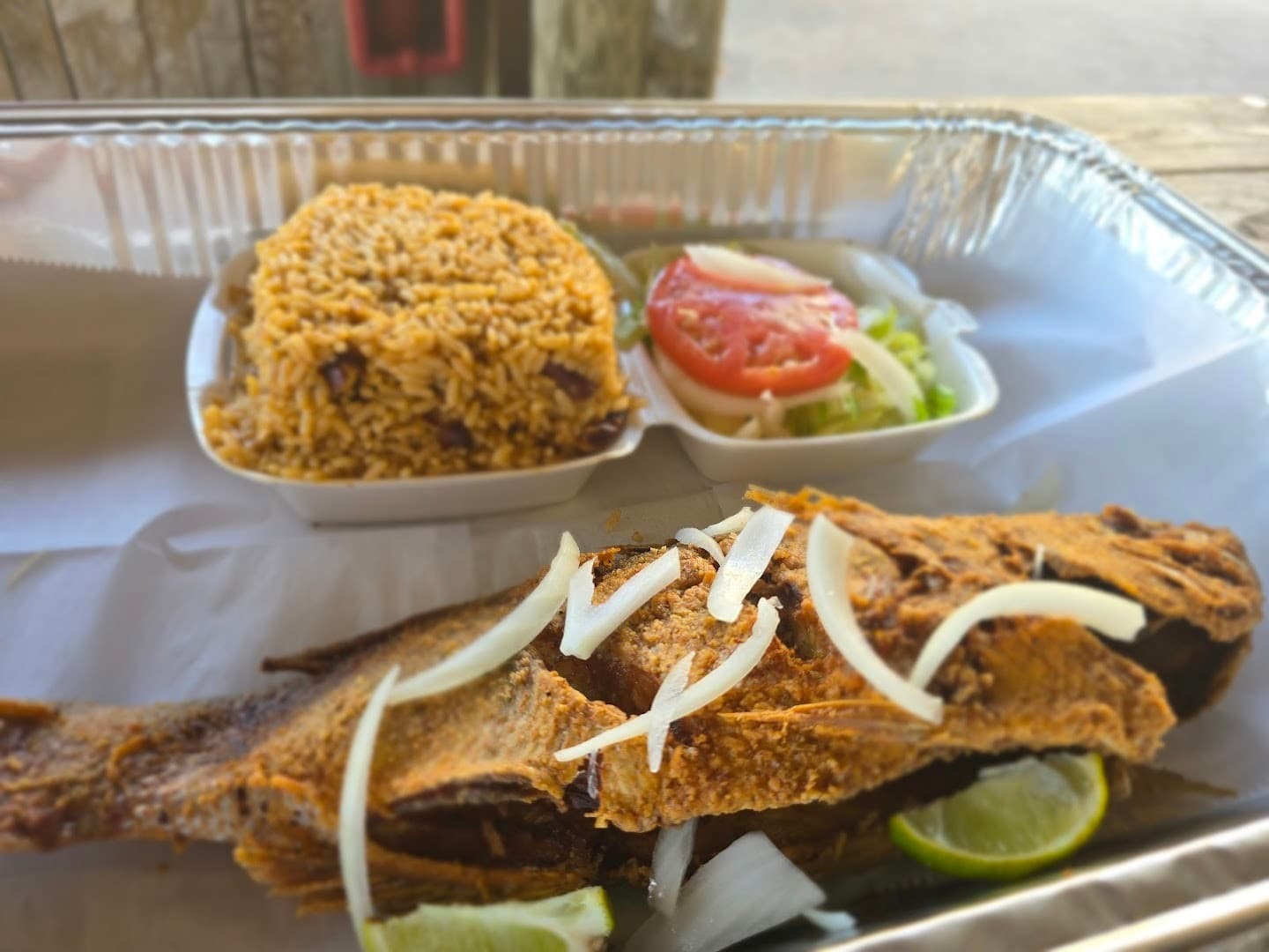 Fried fish with rice and salad at Chef Creole in Miami