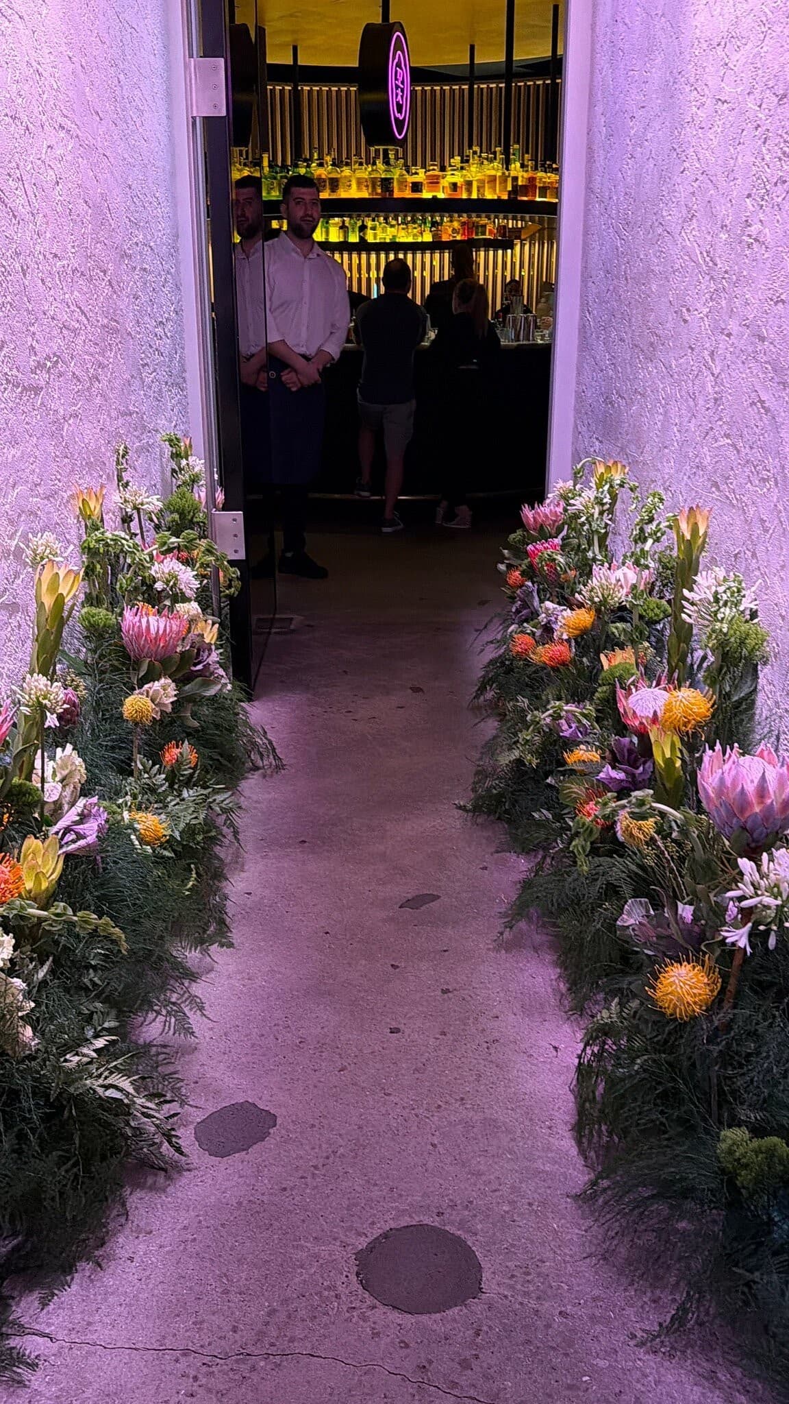 Entrance with floral decor at COTE Miami