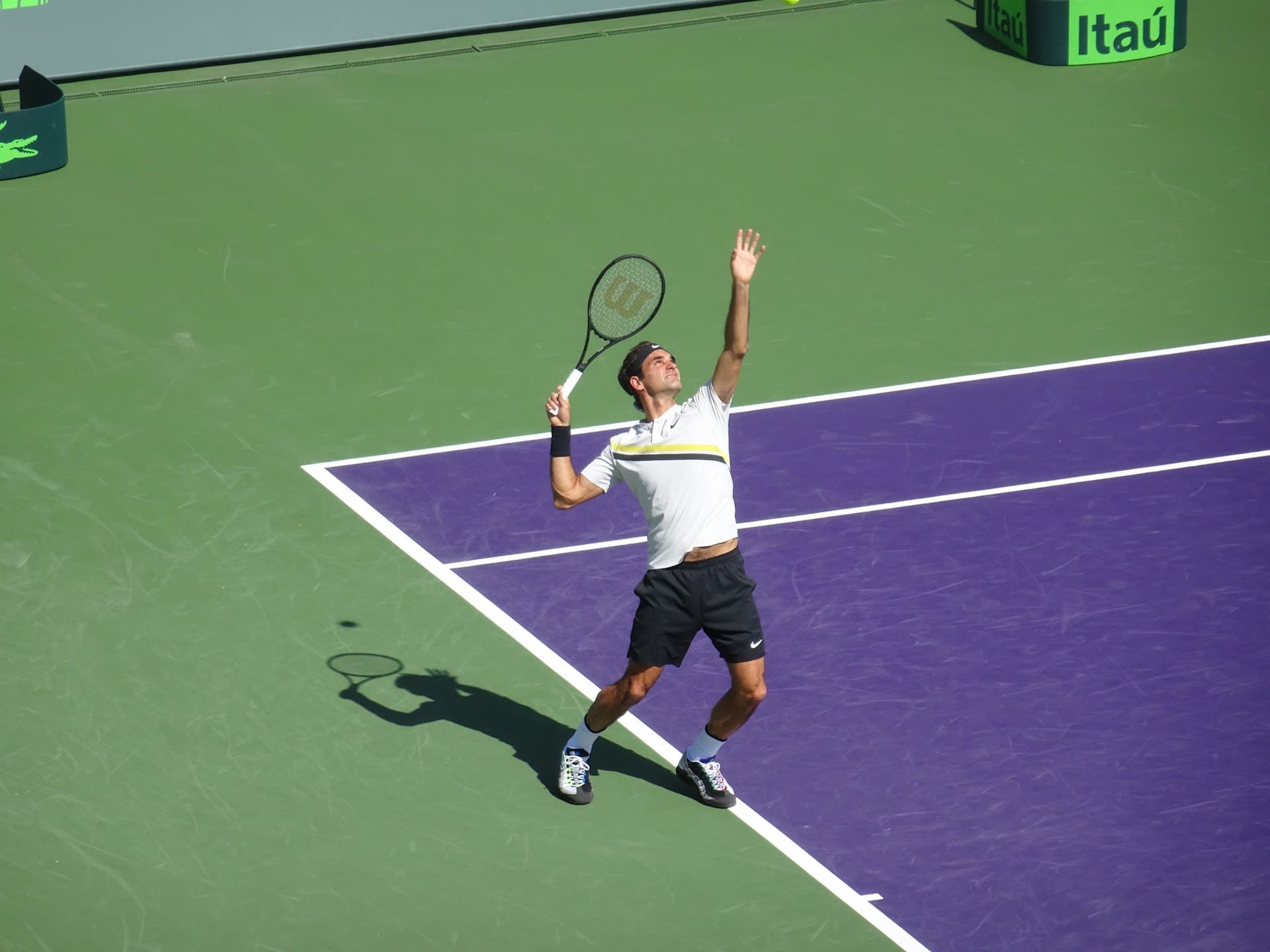 Tennis player serving at Crandon Park Tennis Center Key Biscayne