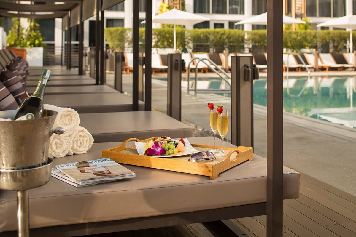 Eden Roc Miami Beach poolside with drinks and fruit