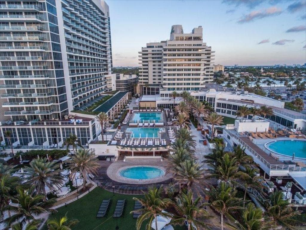 Eden Roc Miami Beach pool area with palm trees