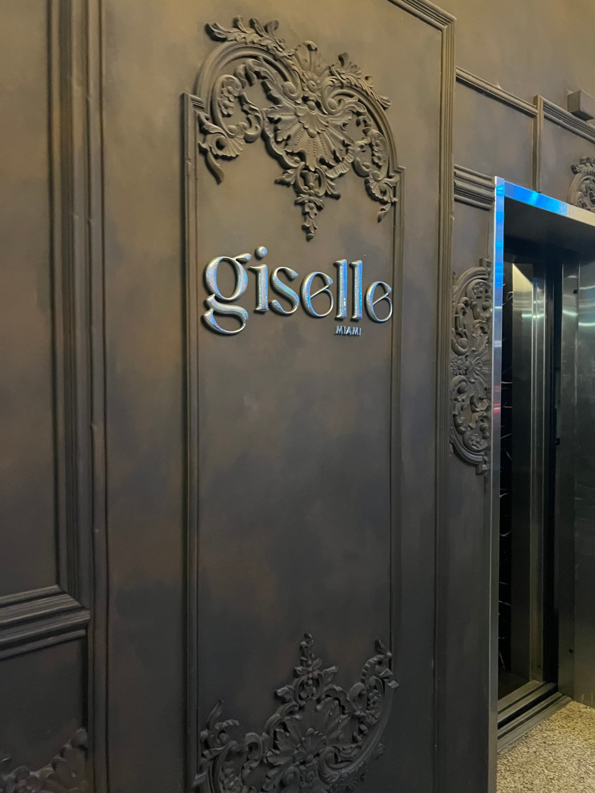 Giselle Miami signage on an elegant wall
