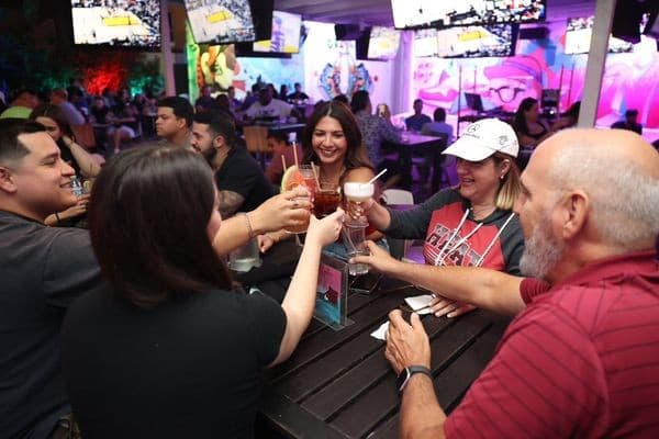 Group enjoying drinks at Grails Miami sports bar