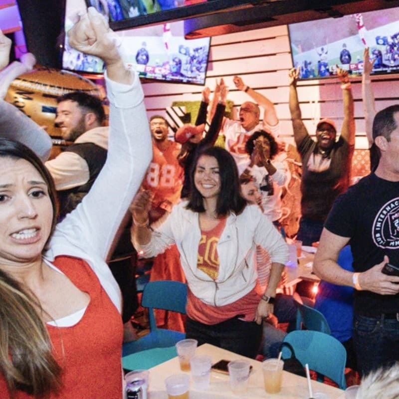 Crowd enjoying sports at Grails Miami restaurant and sports bar