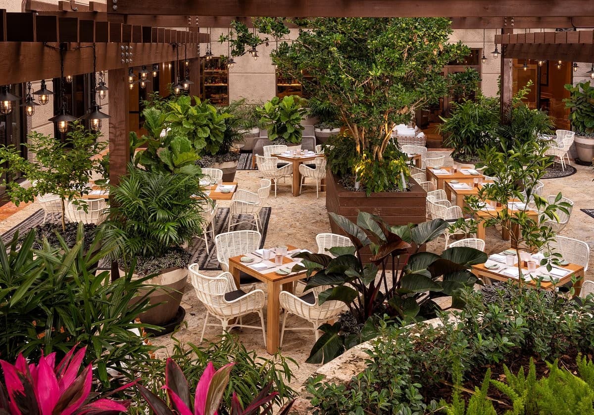 Isabelle’s Coconut Grove dining area with lush greenery in Miami