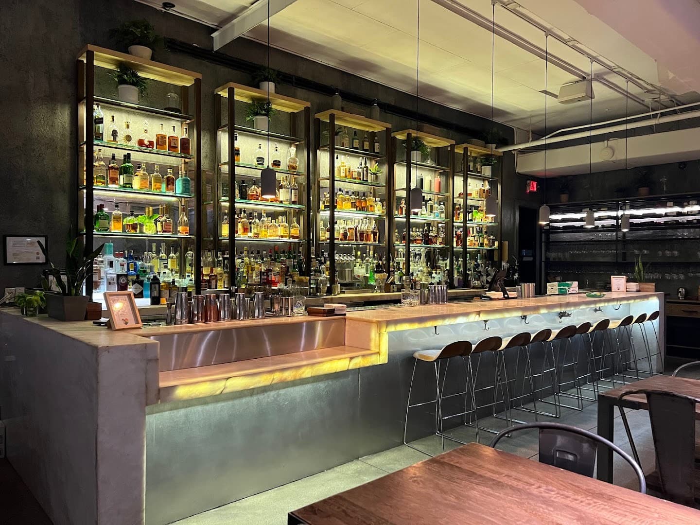 Stylish bar at KYU Miami with various spirits
