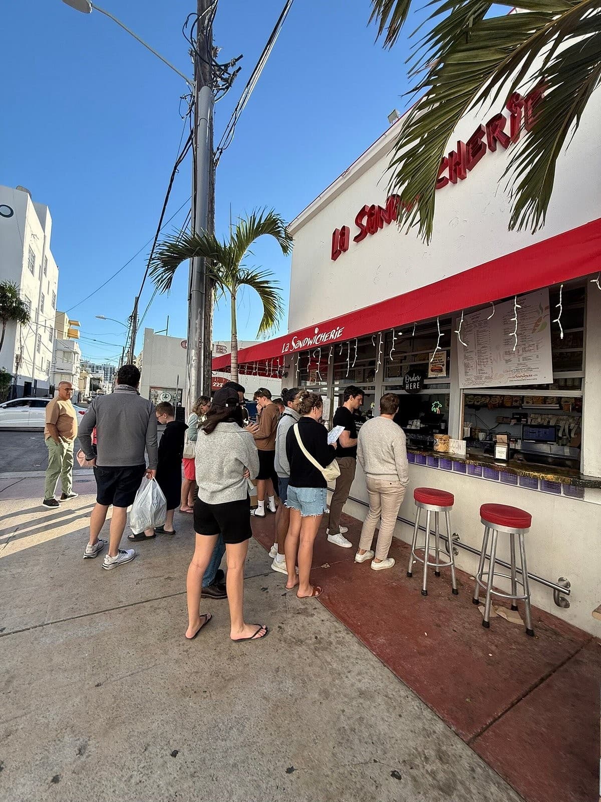 Exterior view of La Sandwicherie Miami Beach with crowd