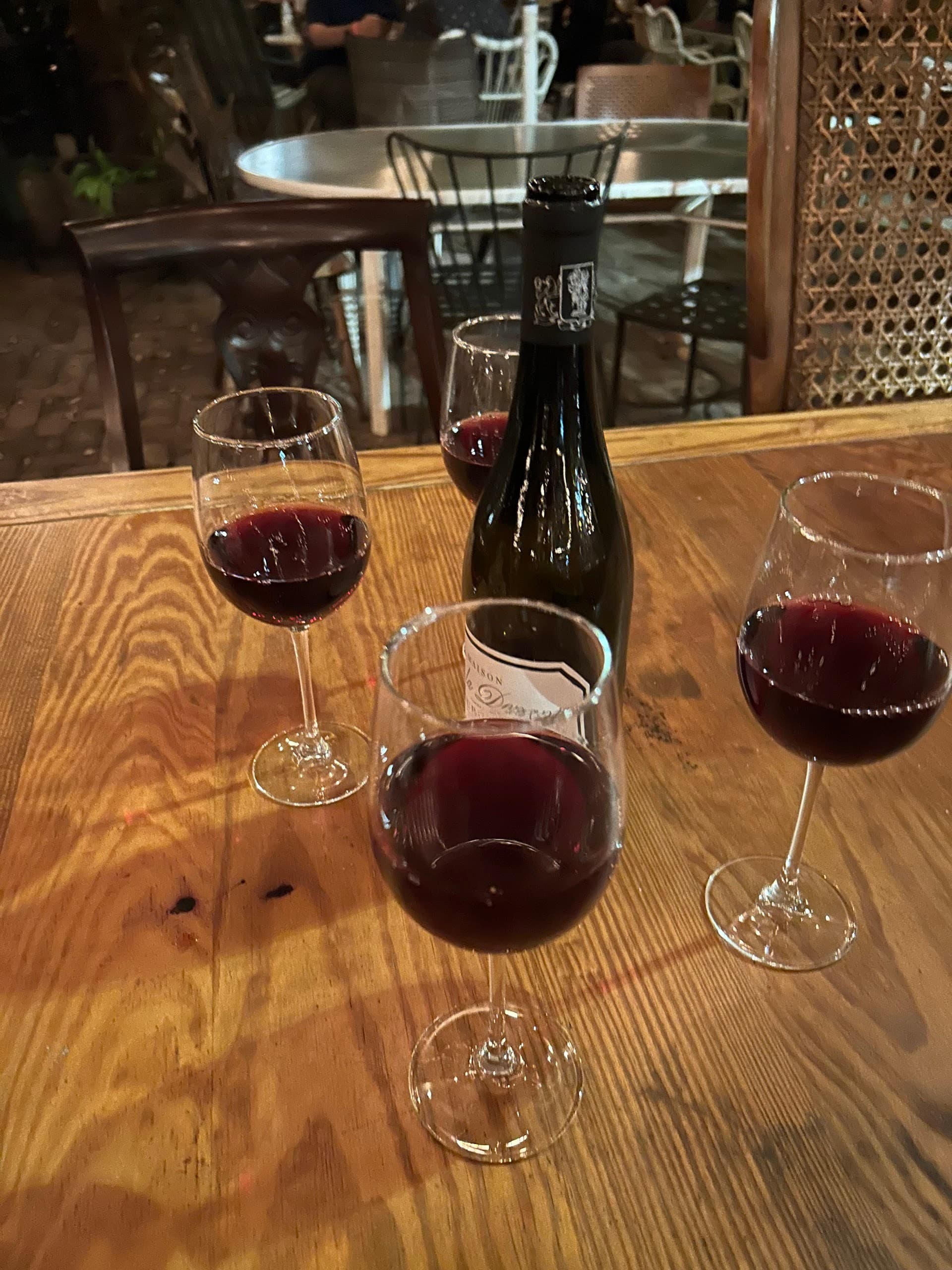 Wine glasses and a bottle at Lagniappe in Miami