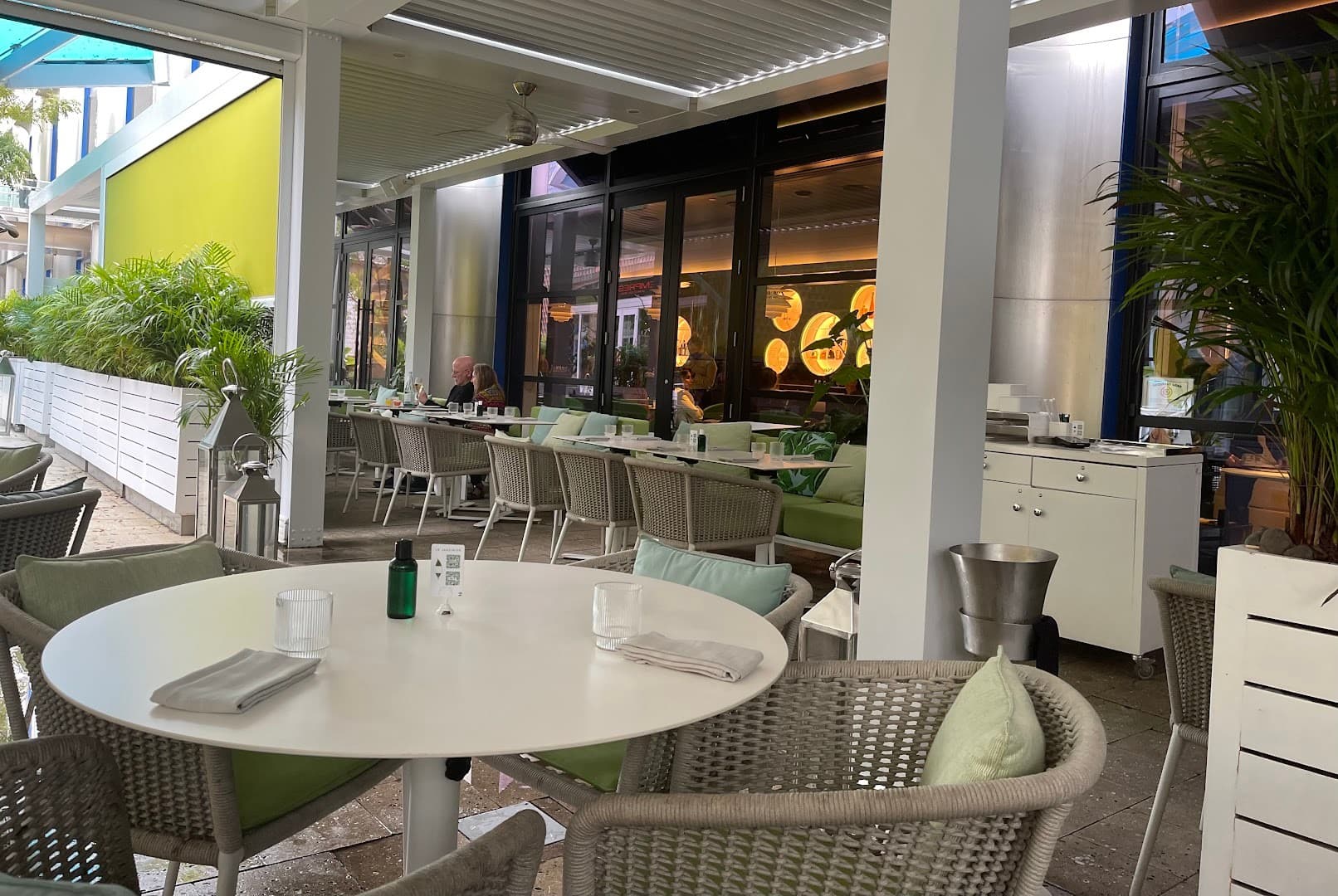 Patio seating at Le Jardinier restaurant in Miami
