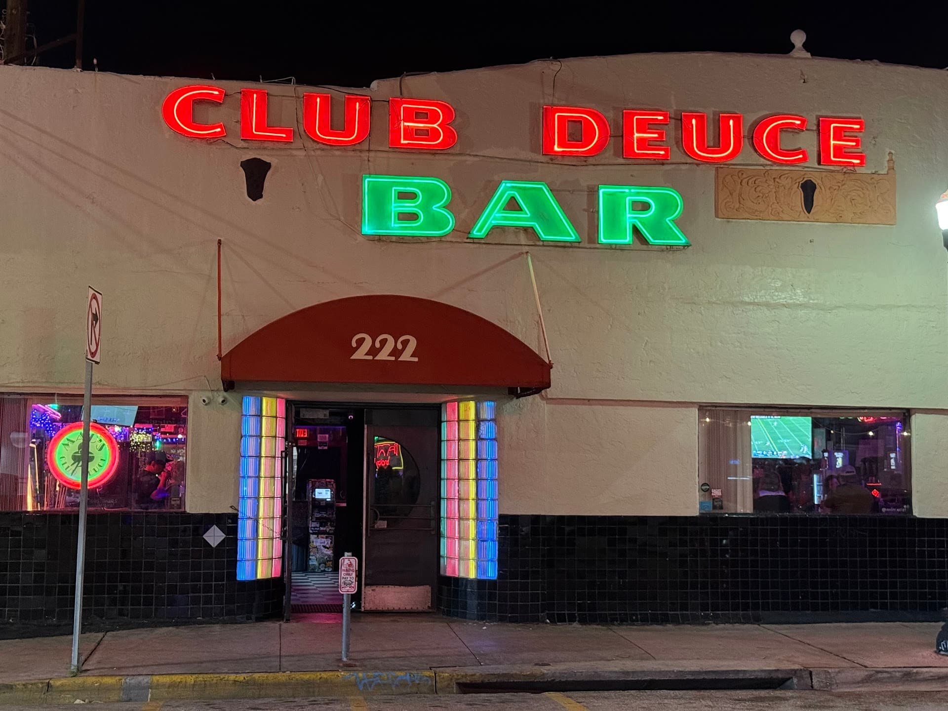Mac's Club Deuce bar exterior at night in Miami Beach