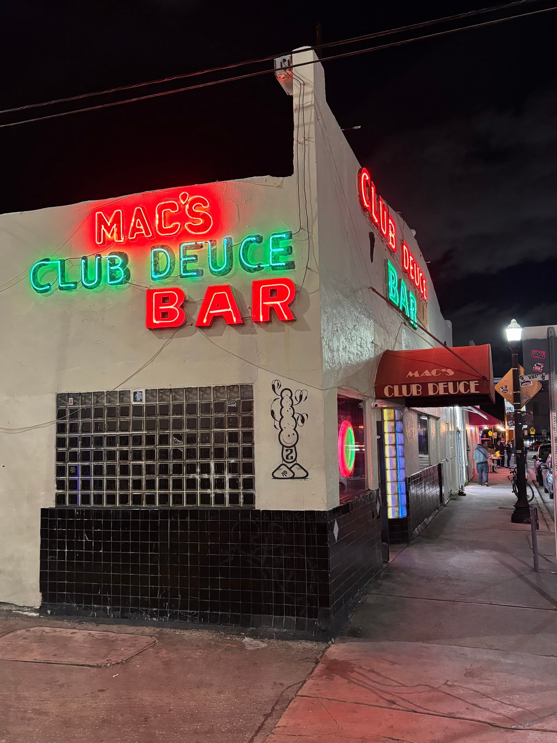 Mac's Club Deuce signage in Miami Beach at night