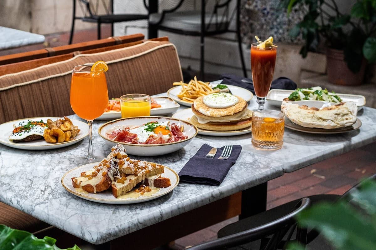 Dining scene at Mayfair Grill in Miami with various dishes