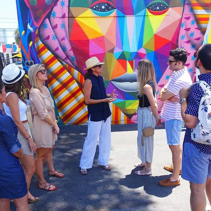 Colorful mural in Miami Beach with a group tour