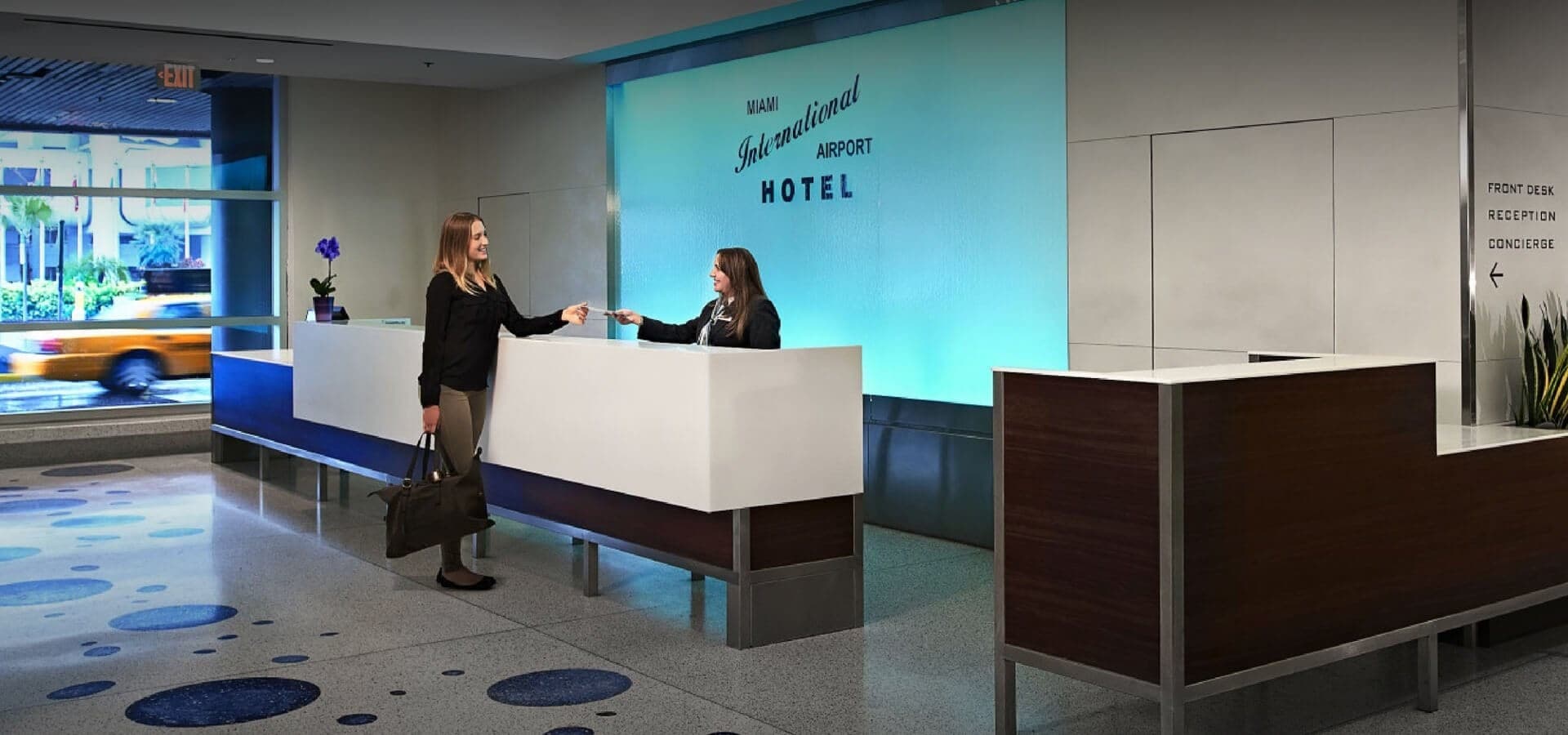 Miami International Airport Hotel lobby with staff and guest