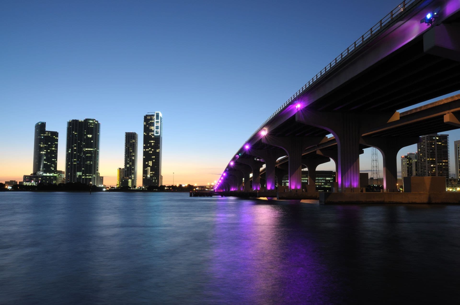 Miami skyline at dusk with illuminated bridge