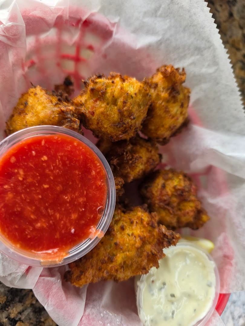 Fried fritters with dipping sauces at Monty's Coconut Grove, Miami