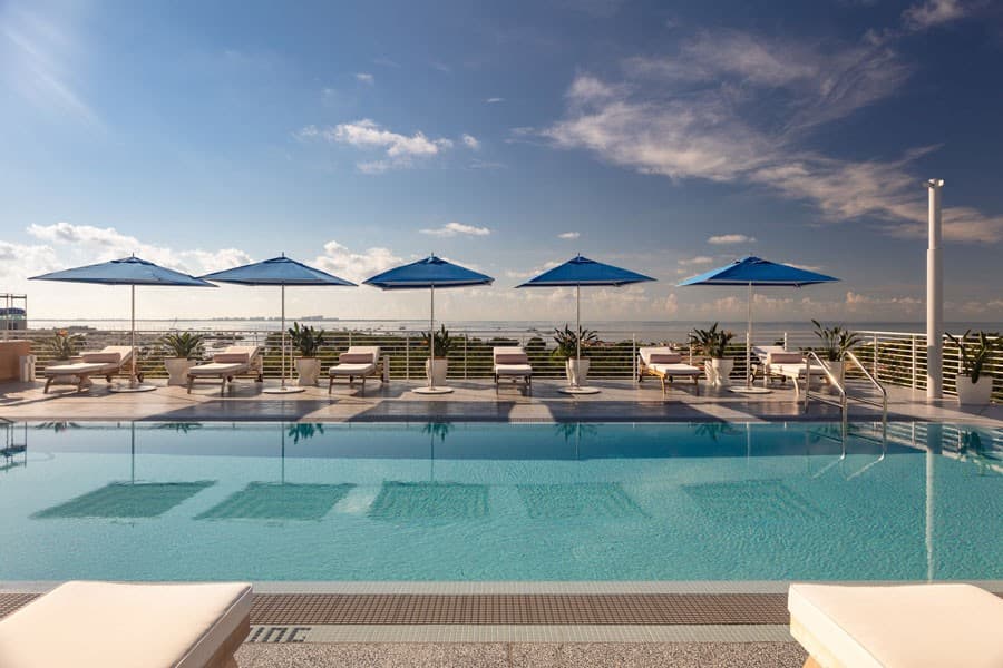 Mr. C Miami pool area with umbrellas in Coconut Grove