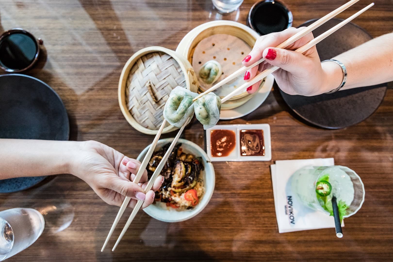 Diners enjoying dumplings at Novikov Miami