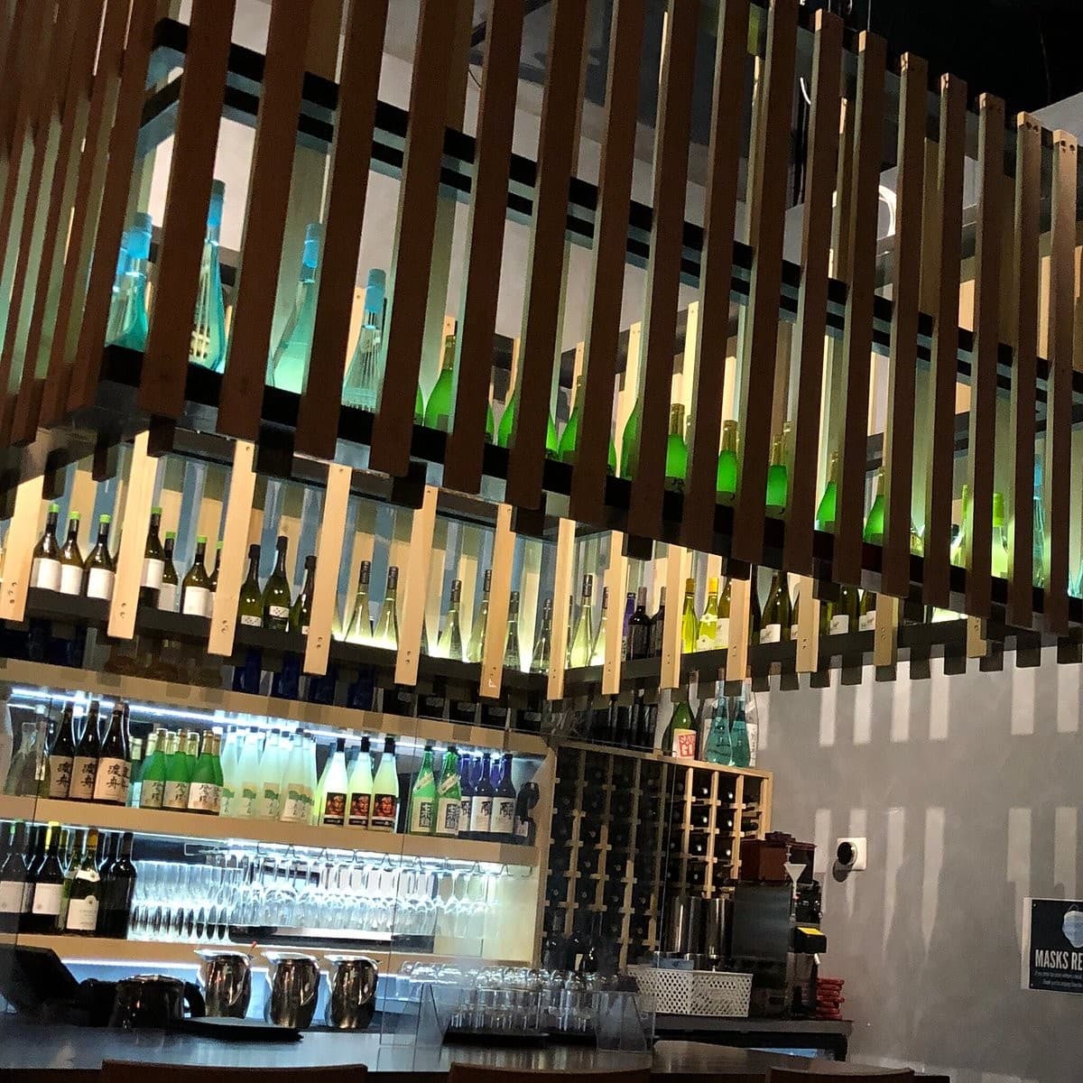 OMAKAI sushi bar area with bottles in Aventura