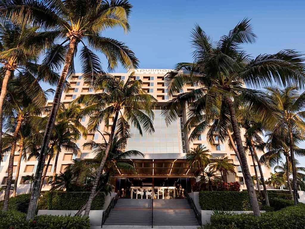 Pullman Miami Airport hotel facade with palm trees