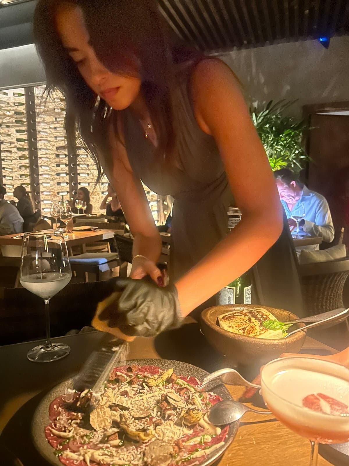 Woman preparing food at RosaNegra Miami restaurant