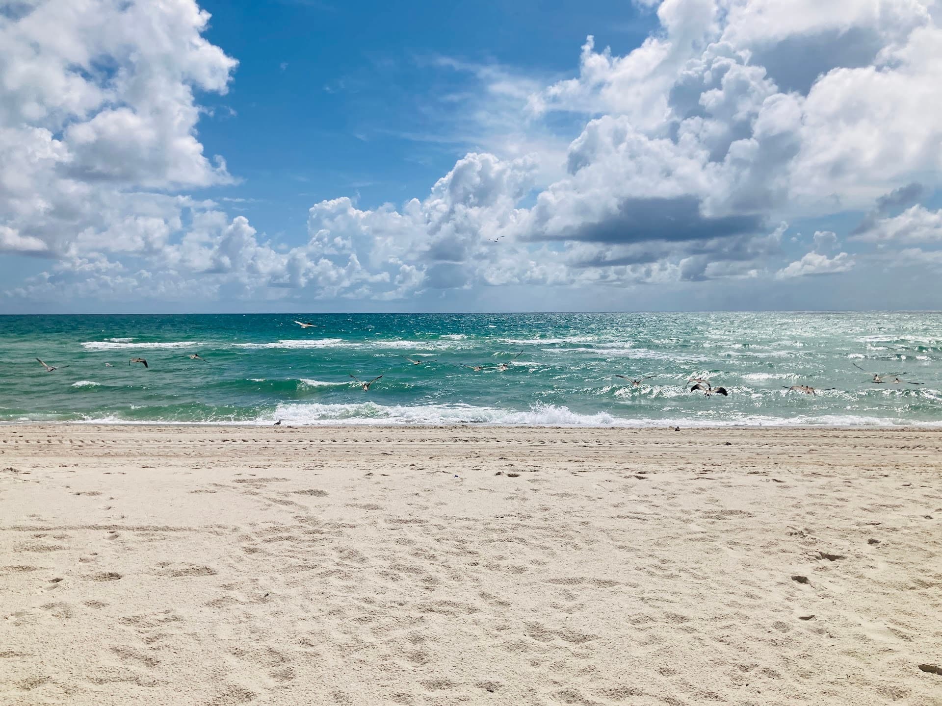 Surfside Beach view in Miami with ocean and clouds