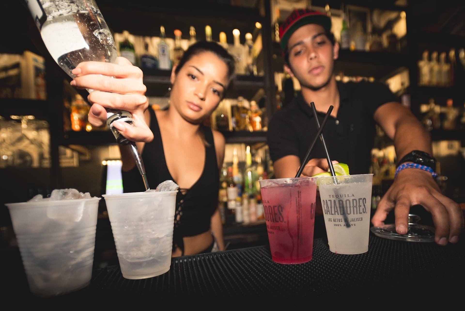 Bartenders serving drinks at Sweet Caroline Karaoke Bar in Miami