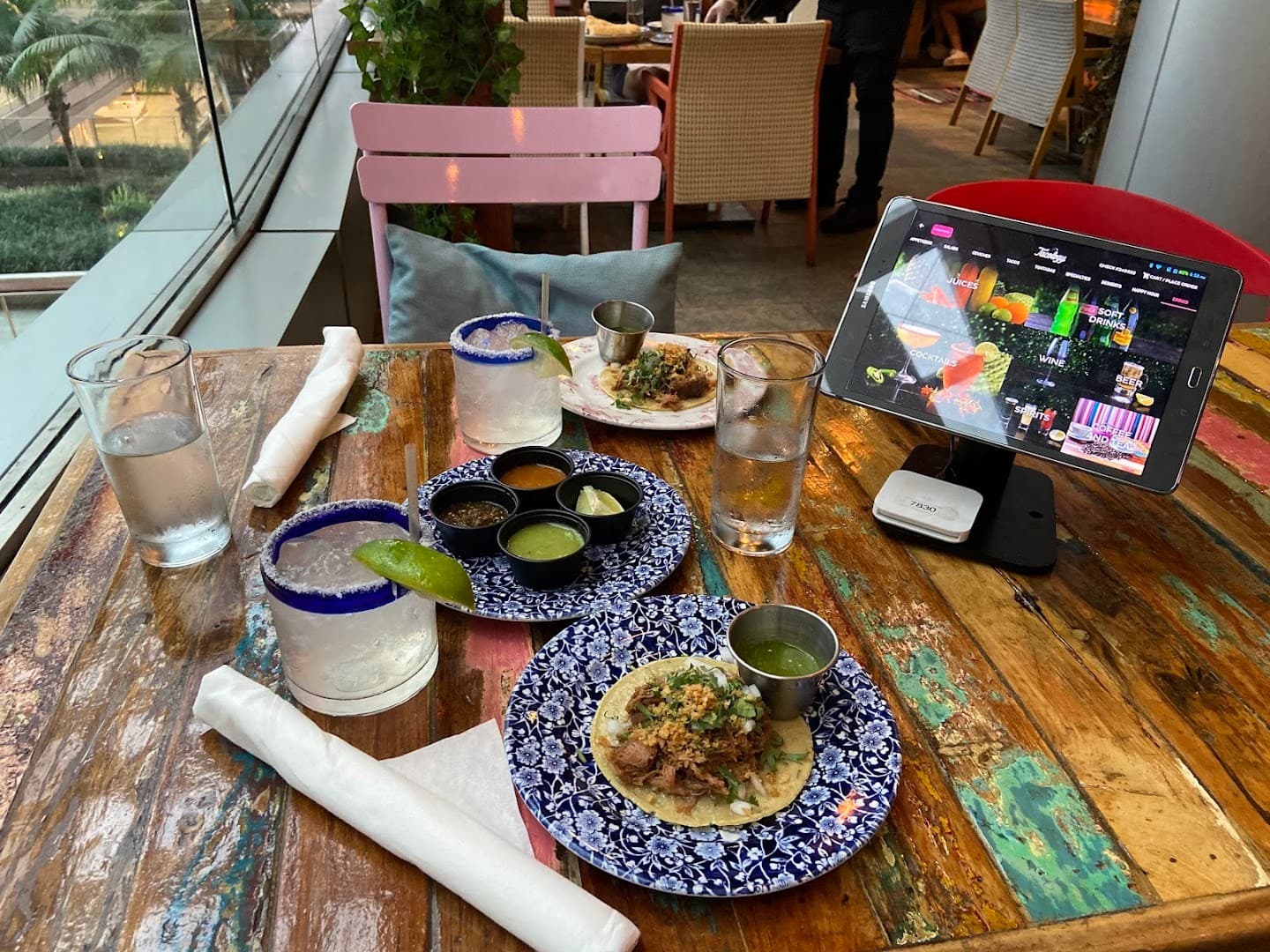 Dining scene at Tacology Brickell with tacos and drinks