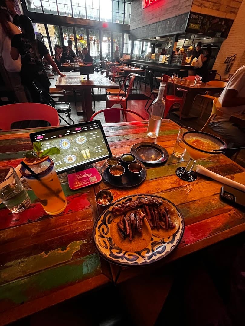 Dining scene at Tacology Brickell featuring tacos and drinks