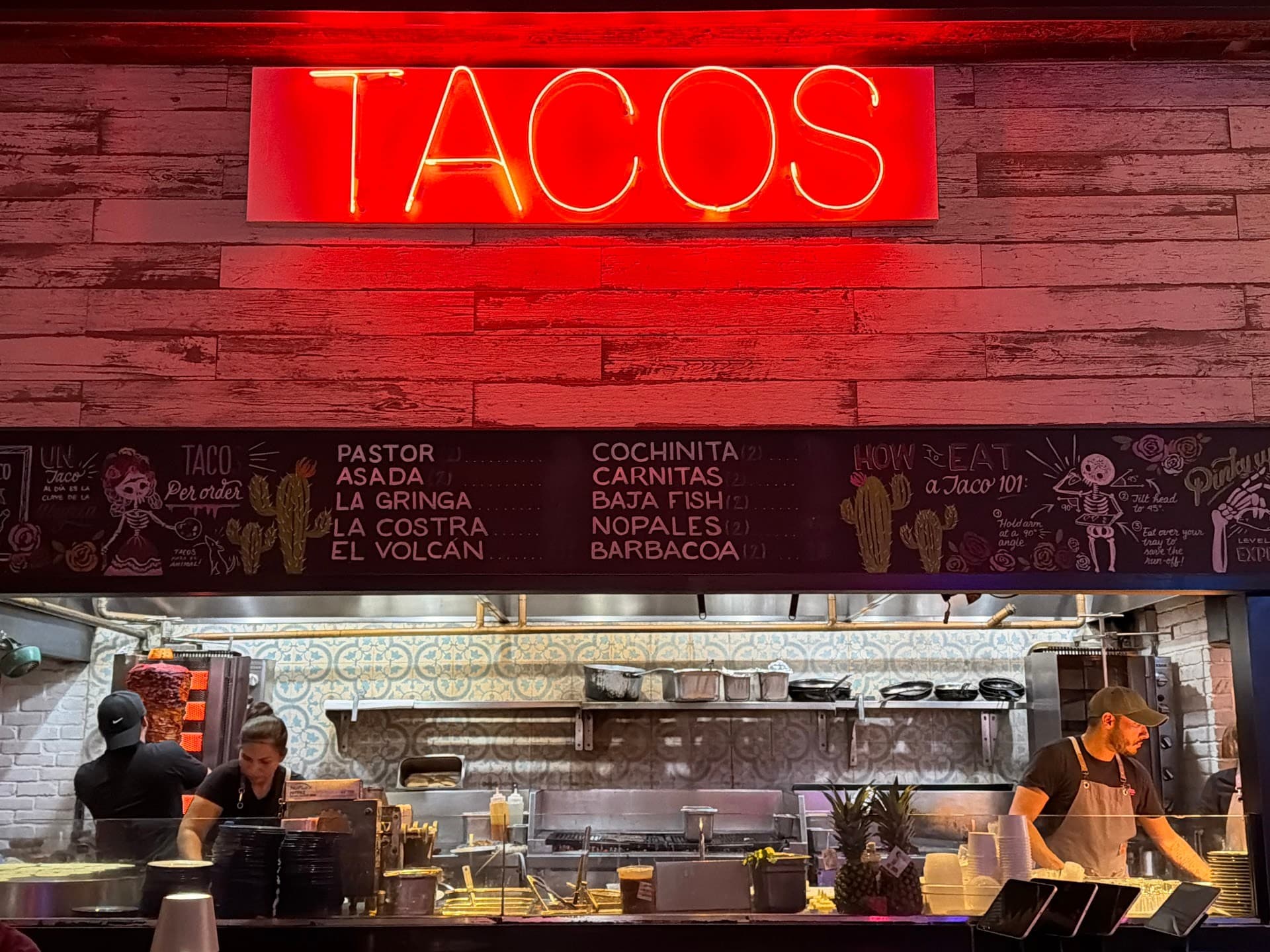 Tacology Brickell vibrant interior featuring Tacos sign