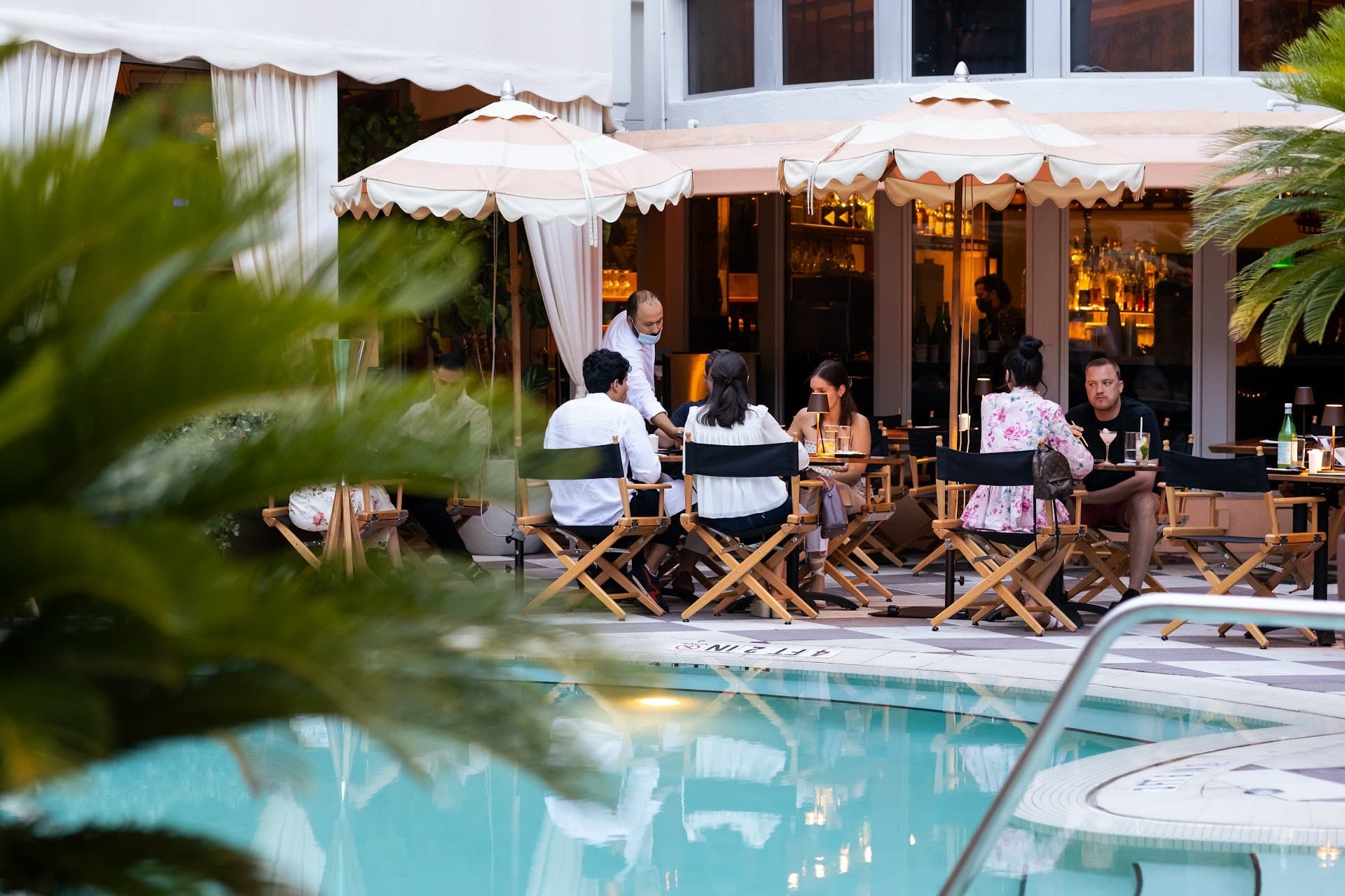 Dining by the pool at The Plymouth South Beach, Miami Beach
