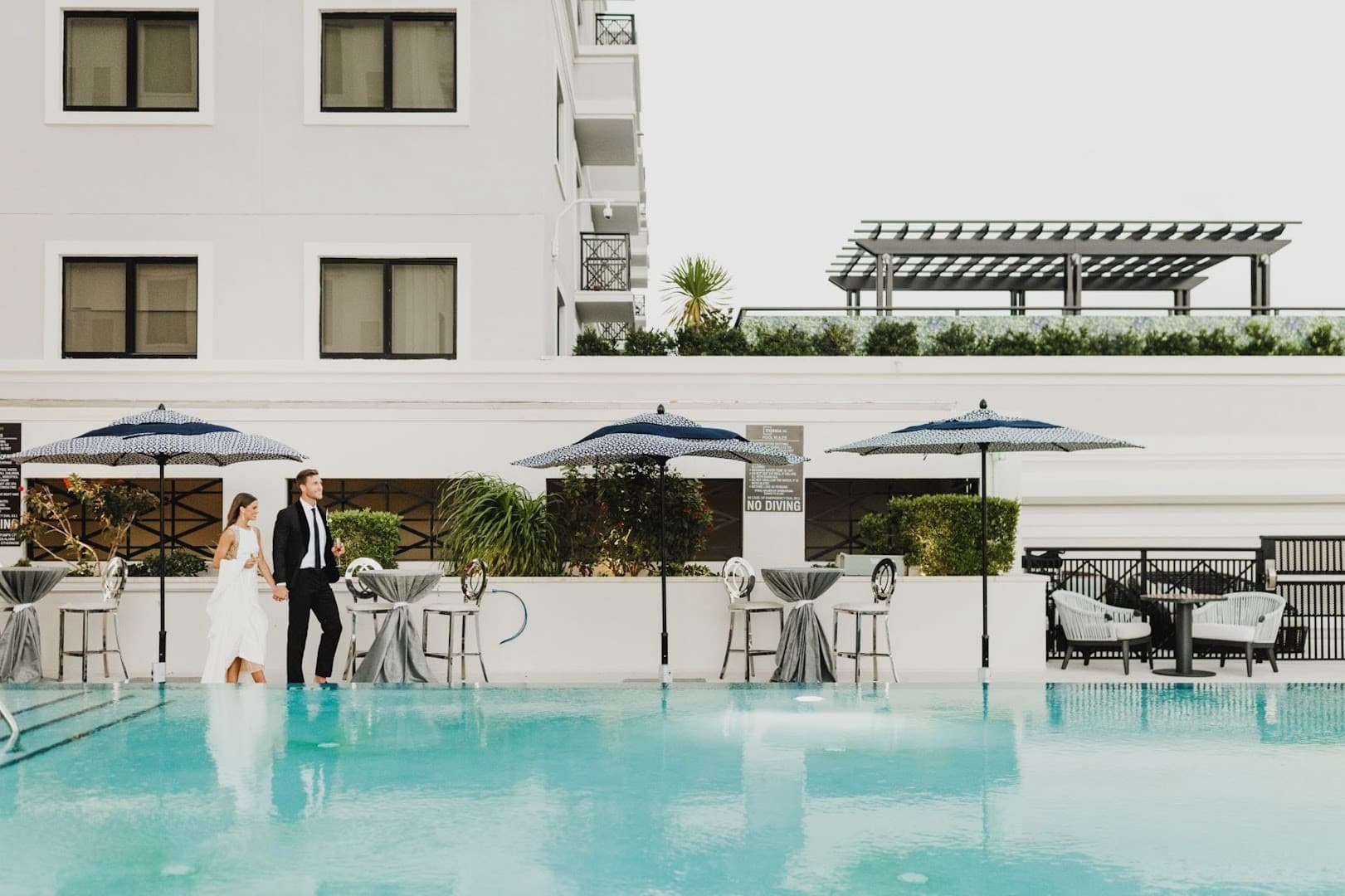 Couple enjoying the pool area at Thesis Hotel Coral Gables